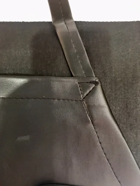 Premium black neck strap apron for cooking and grilling. Stylish and durable accessory.