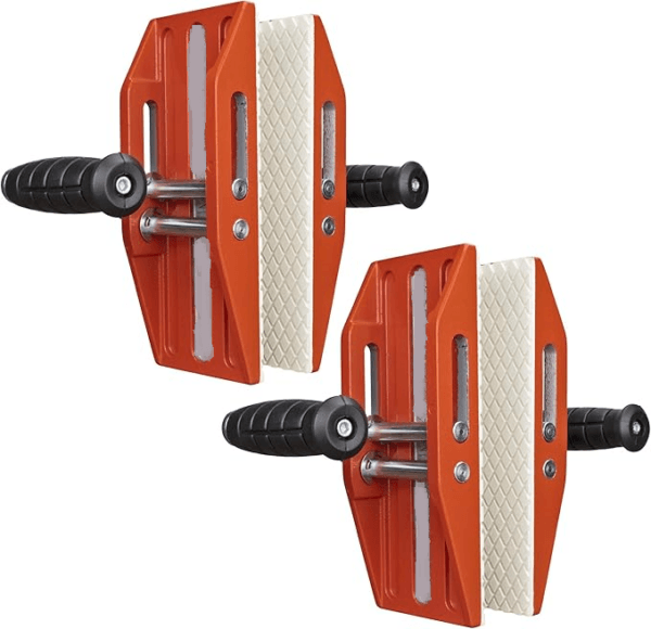 The Carry Clamps Double Handle | Pair features a sturdy metal construction with two orange corner clamps, black handles, and white rubber pads for securely holding materials at a 90-degree angle. These clamps are perfect for woodworking or framing projects, providing precision and ease of use with their double-handle design.