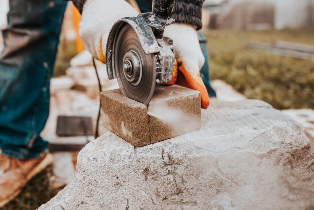 Properly Maintain Your Stone Cutting Tools for Long-Term Performance 1 Diamond blade grinder efficiently cuts concrete blocks for stone tile sidewalk installation.